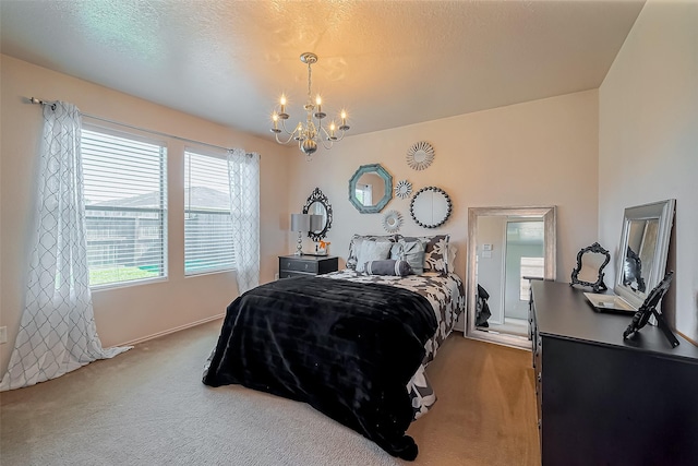 carpeted bedroom featuring a notable chandelier and a textured ceiling