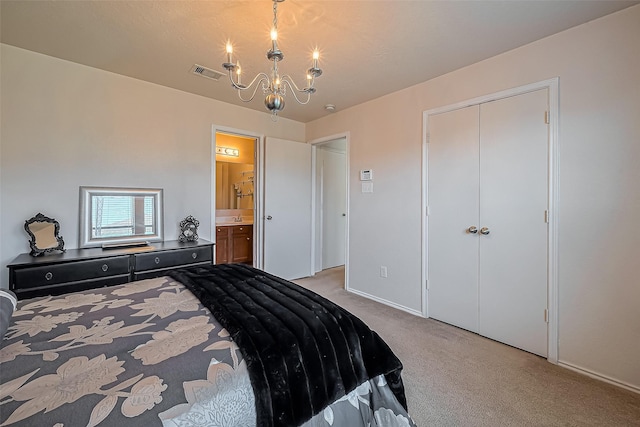 bedroom with visible vents, a closet, a notable chandelier, light colored carpet, and connected bathroom