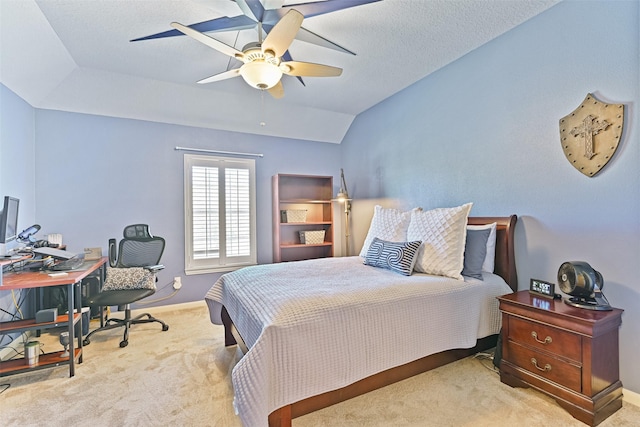 carpeted bedroom with a textured ceiling, vaulted ceiling, baseboards, and ceiling fan