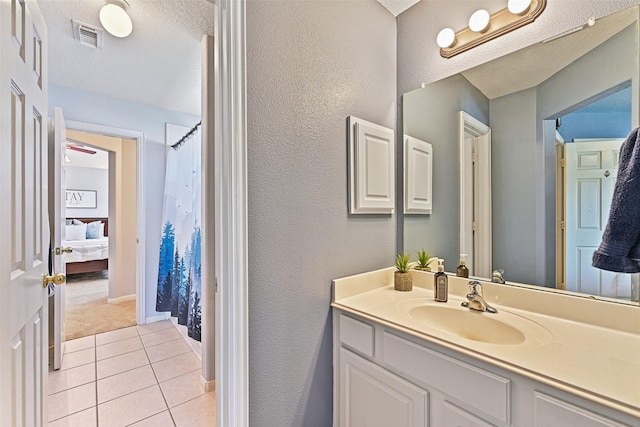 bathroom with vanity, a shower with shower curtain, visible vents, a textured ceiling, and tile patterned floors