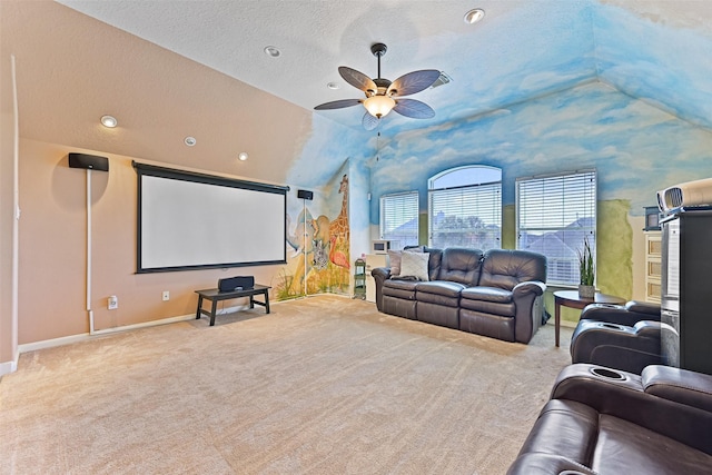 home theater featuring baseboards, carpet, lofted ceiling, a textured ceiling, and a ceiling fan