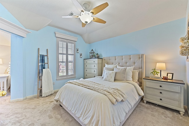 carpeted bedroom with lofted ceiling, a ceiling fan, and baseboards