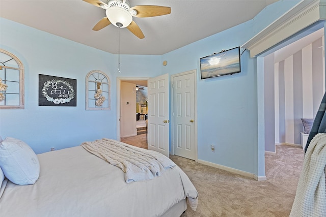 carpeted bedroom featuring ceiling fan and baseboards