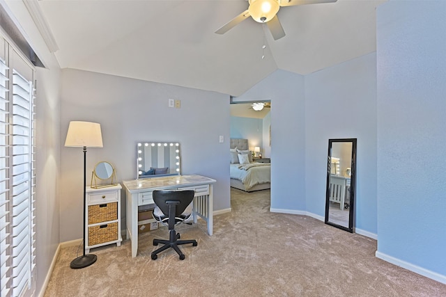 carpeted home office with baseboards, a ceiling fan, and vaulted ceiling