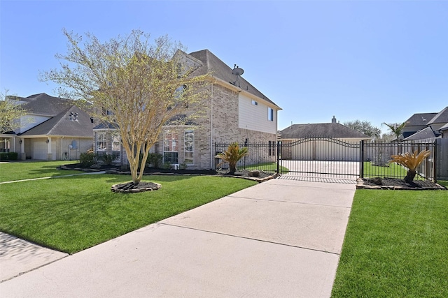 view of home's exterior with brick siding, fence, a lawn, driveway, and a gate