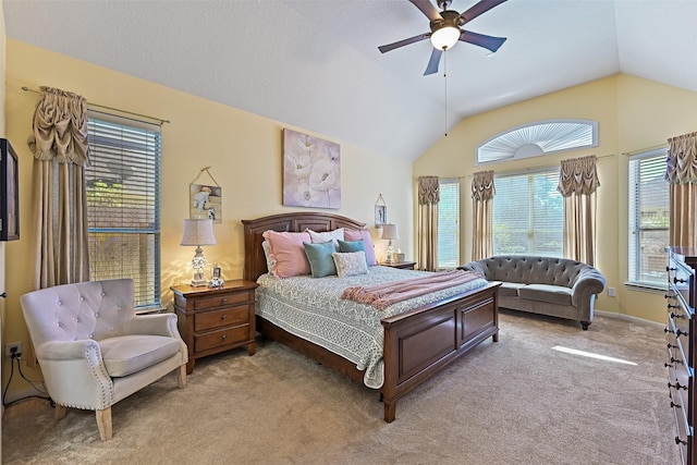 bedroom featuring baseboards, light colored carpet, ceiling fan, and vaulted ceiling