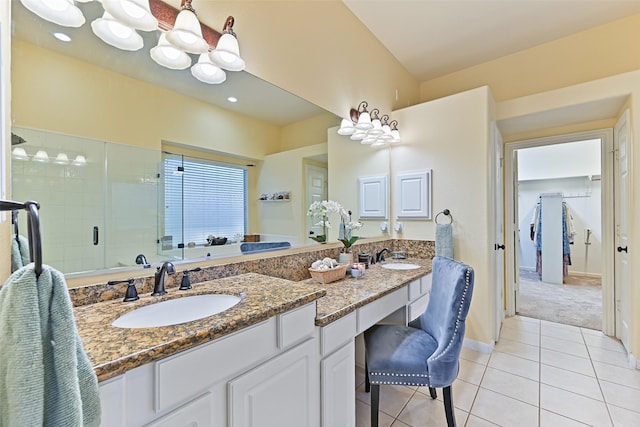 full bathroom with a sink, double vanity, a shower stall, and tile patterned flooring