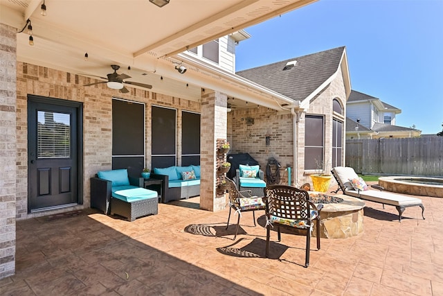 view of patio / terrace with an outdoor living space with a fire pit, ceiling fan, and fence