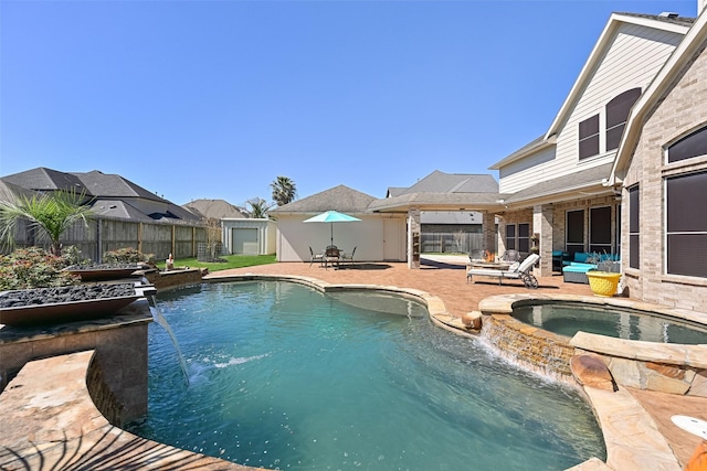 view of swimming pool with a patio, a fenced backyard, and a pool with connected hot tub