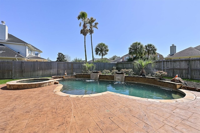 view of pool featuring a pool with connected hot tub, a patio area, and a fenced backyard