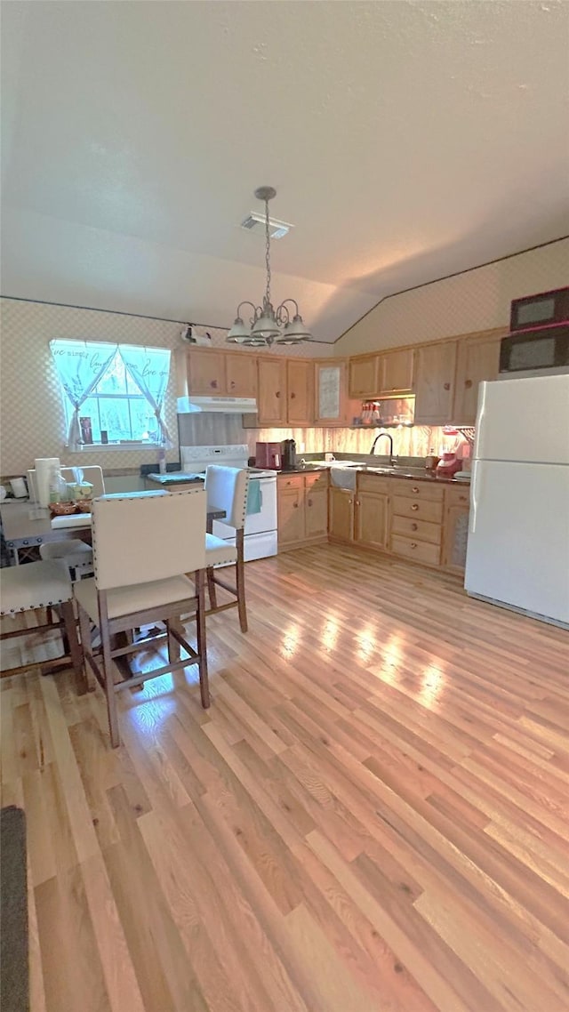 interior space with visible vents, an inviting chandelier, light wood-style flooring, and vaulted ceiling