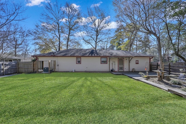 back of house with a yard, central AC unit, and a fenced backyard