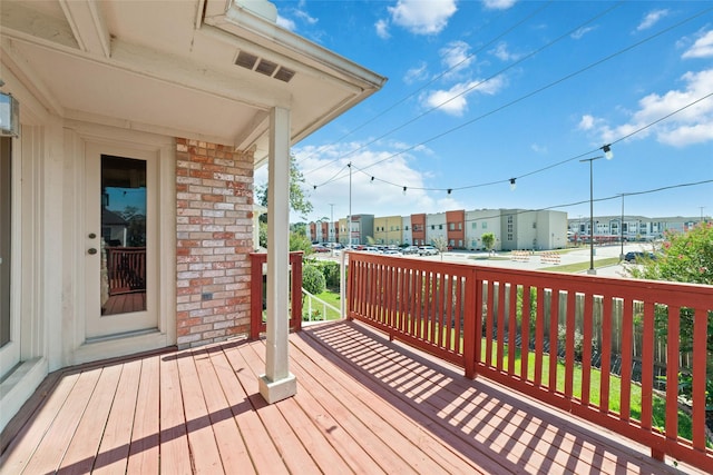 wooden deck featuring a residential view