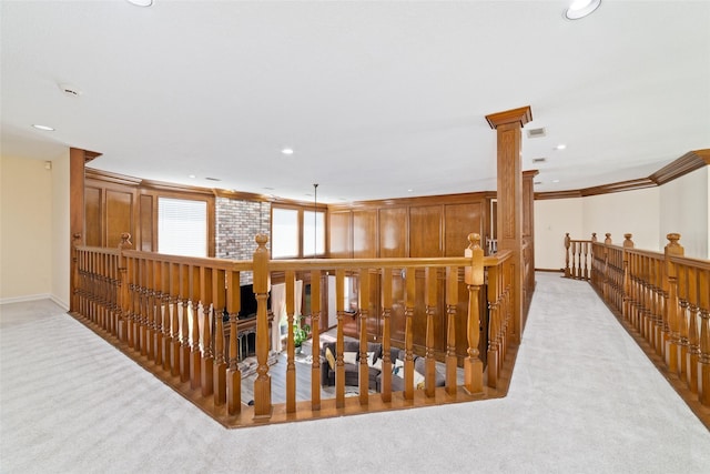 corridor with recessed lighting, crown molding, carpet, and decorative columns