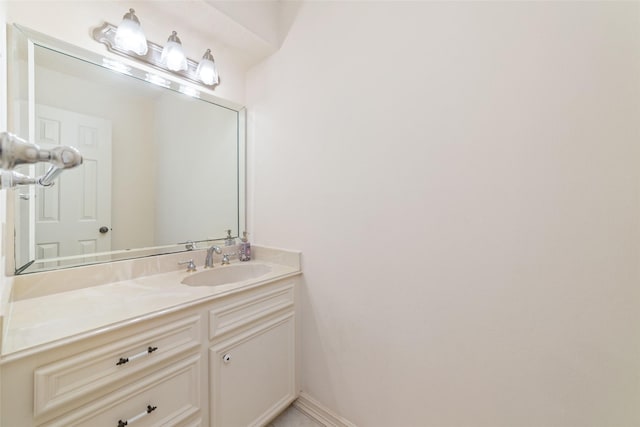 bathroom with vanity and baseboards