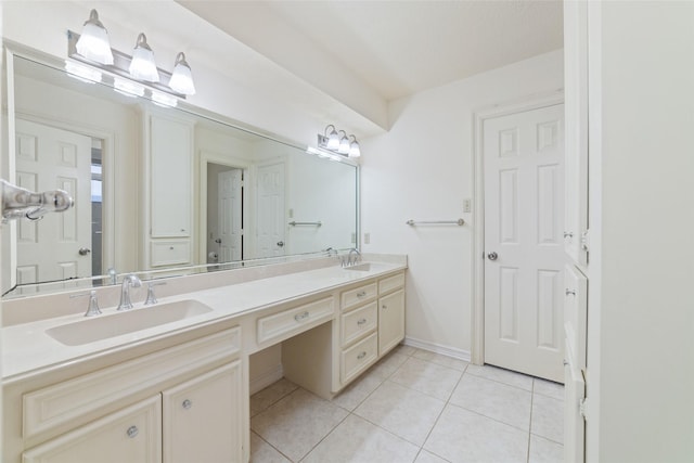 bathroom featuring tile patterned floors, double vanity, baseboards, and a sink