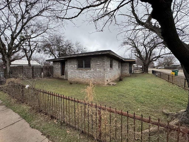 view of side of property with a yard and a fenced backyard