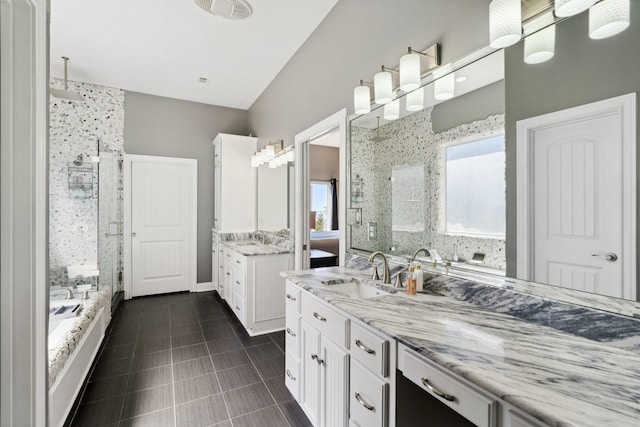 bathroom with tile patterned flooring, a shower stall, two vanities, and a sink