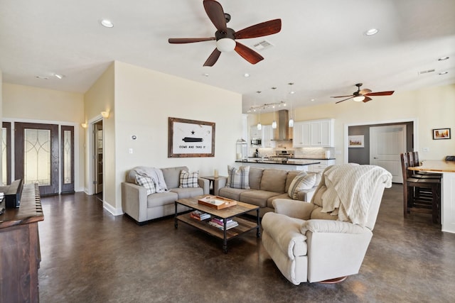 living room featuring finished concrete floors, recessed lighting, visible vents, and ceiling fan