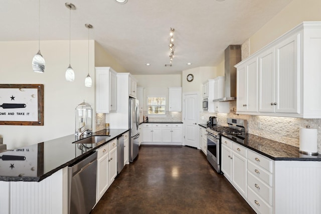 kitchen with a peninsula, appliances with stainless steel finishes, wall chimney exhaust hood, decorative backsplash, and concrete flooring
