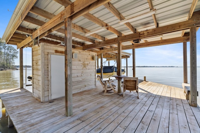 view of dock with boat lift and a water view