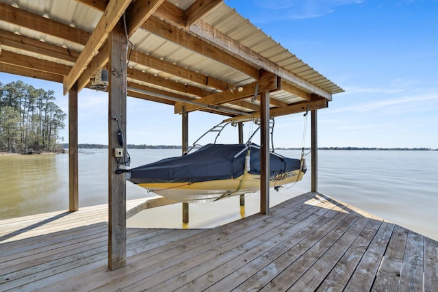 dock area with boat lift and a water view