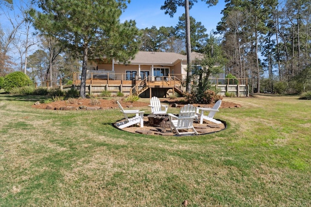 view of yard featuring a fire pit, stairs, and a deck