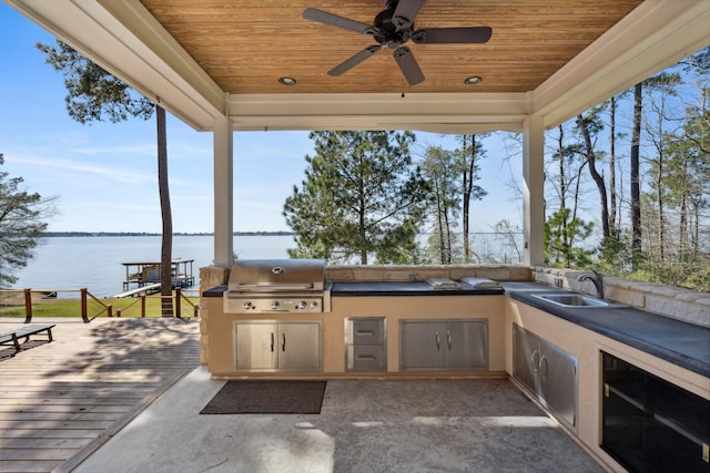 view of patio with a grill, exterior kitchen, ceiling fan, and a sink