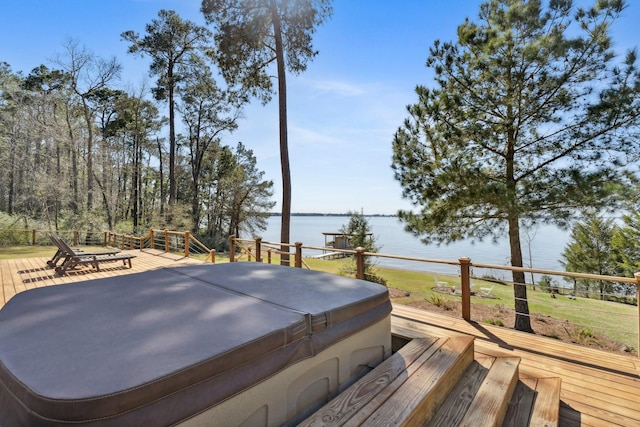 deck featuring a water view and a hot tub