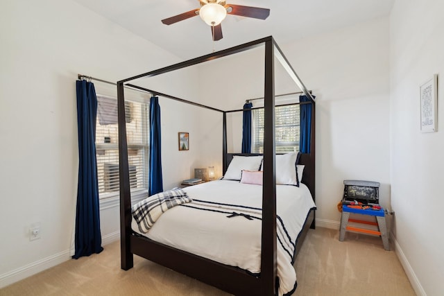 bedroom featuring baseboards and light carpet