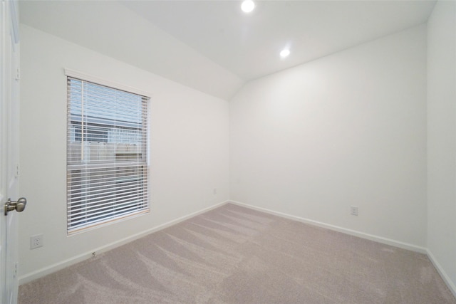 carpeted empty room with recessed lighting, baseboards, and lofted ceiling