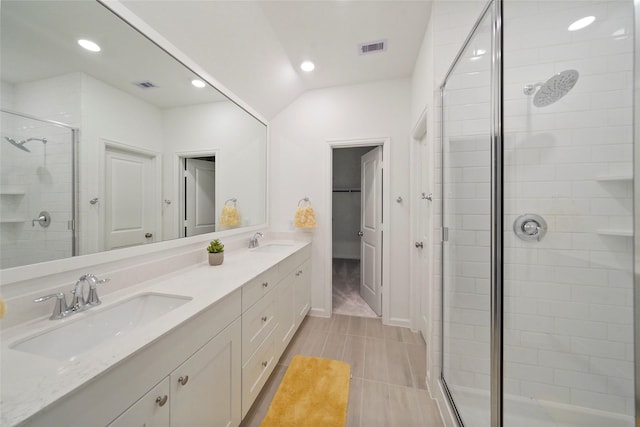 bathroom with a shower stall, visible vents, and a sink