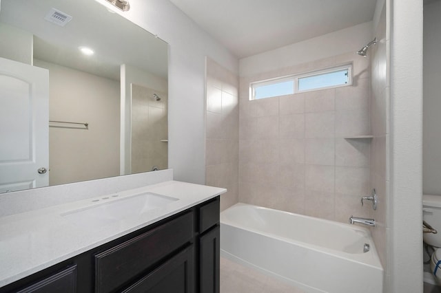 bathroom featuring visible vents, vanity, washtub / shower combination, and toilet