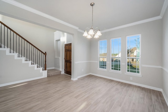 empty room with baseboards, a notable chandelier, stairs, and light wood finished floors