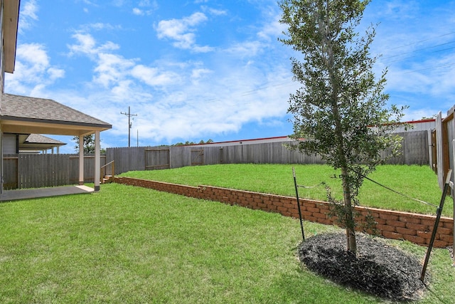 view of yard with a fenced backyard