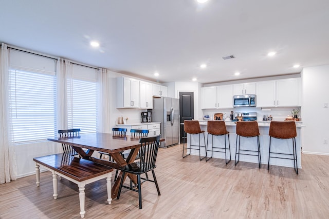 dining room featuring recessed lighting, visible vents, light wood-type flooring, and baseboards