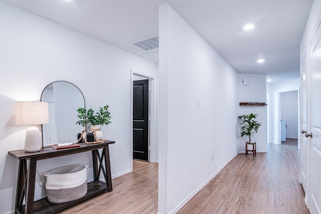 hall with recessed lighting, visible vents, baseboards, and light wood finished floors