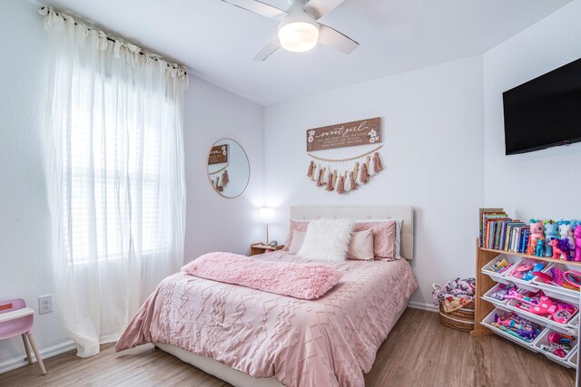 bedroom with wood finished floors, baseboards, and ceiling fan