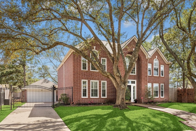 view of front facade featuring driveway, fence, a front yard, and a gate