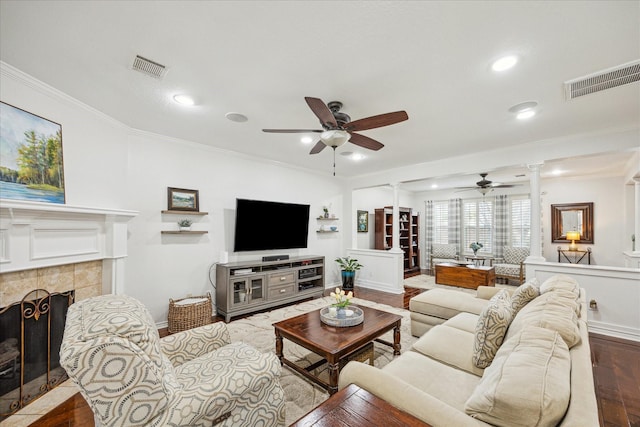 living room with crown molding, visible vents, and ceiling fan