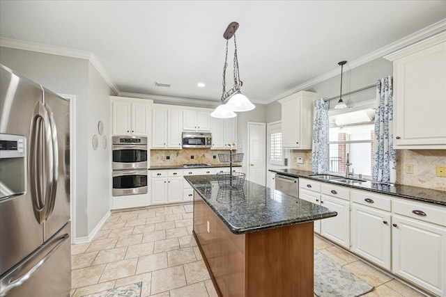 kitchen featuring a sink, a center island, white cabinetry, stainless steel appliances, and crown molding