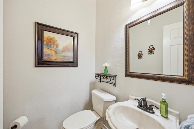 bathroom featuring toilet and a sink