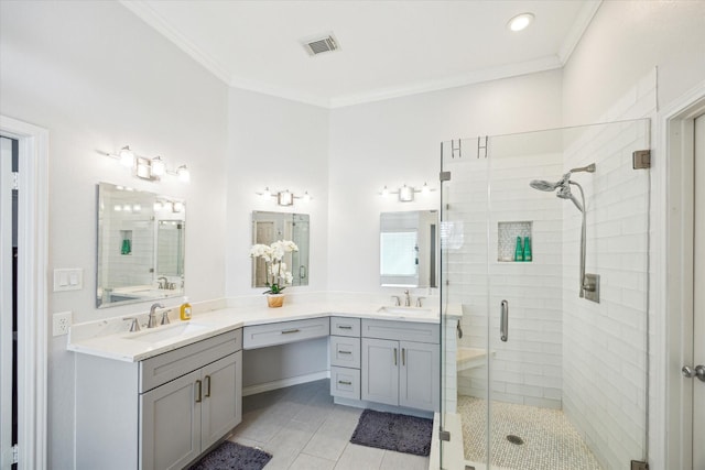 bathroom featuring visible vents, ornamental molding, and a sink