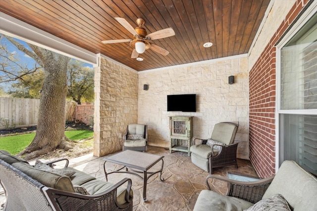 view of patio with an outdoor living space, a ceiling fan, and fence