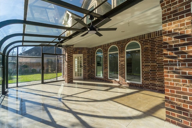 unfurnished sunroom with a ceiling fan