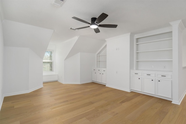 bonus room with a ceiling fan, visible vents, baseboards, lofted ceiling, and light wood-style flooring