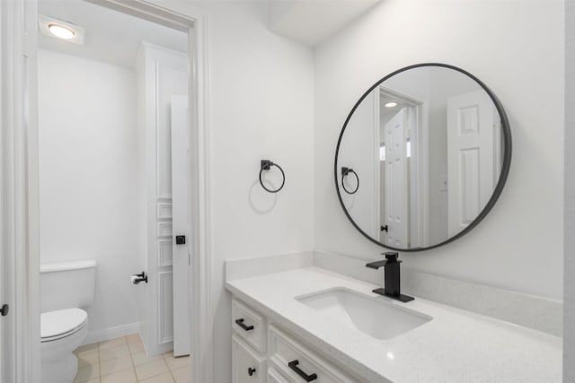 bathroom featuring vanity, tile patterned floors, toilet, and baseboards