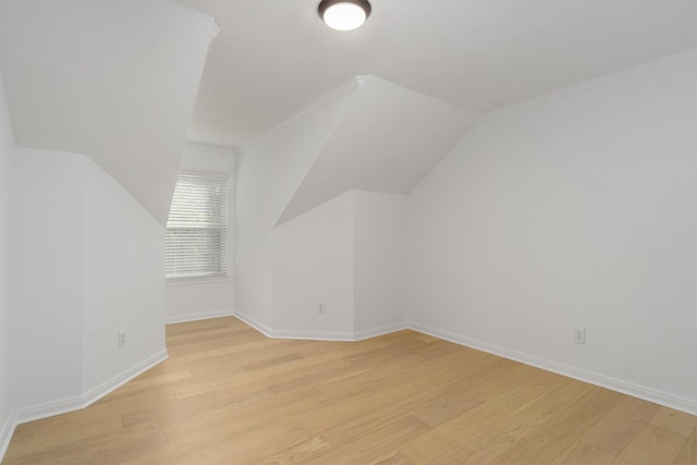 bonus room featuring baseboards, lofted ceiling, and light wood-style floors