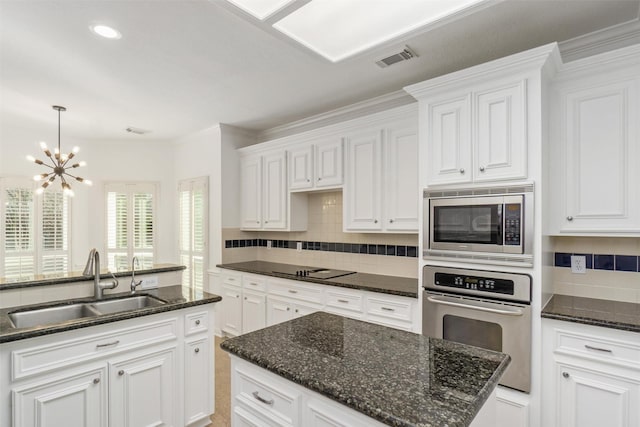 kitchen featuring a sink, stainless steel appliances, visible vents, and white cabinets