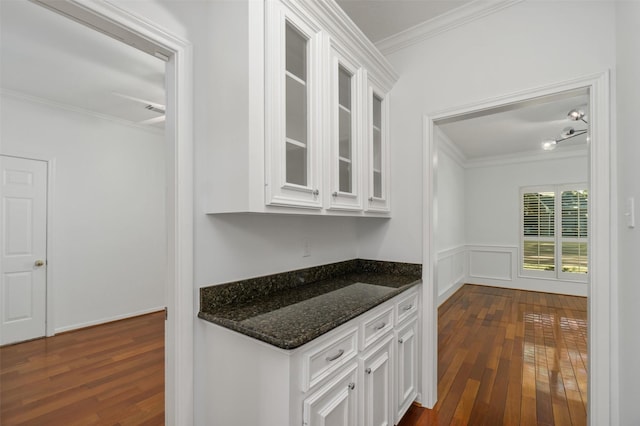 kitchen featuring glass insert cabinets, white cabinets, and crown molding